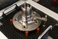 Stainless steel flange as measured component placed on precise measurement base by Mitutoyo