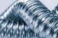 Stainless steel flexible hoses and flexi pipes, fittings and pressure joints close-up mackro. Industrial metal concept