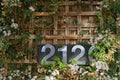 Stainless steel house number plate 2120 on a wood background