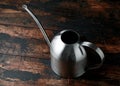 Stainless steel indoor plants watering can pot on dark background Royalty Free Stock Photo