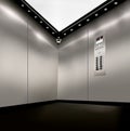 Stainless steel inside of elevator lift with corner camera,  buttons and lights Royalty Free Stock Photo