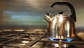 Stainless steel kettle is on cooking gas stove and boiling water. Royalty Free Stock Photo