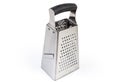 Stainless steel kitchen box four-sided grater on white background Royalty Free Stock Photo