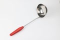 Stainless steel ladle with red handle for cooking Royalty Free Stock Photo
