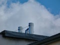 Stainless steel mechanical air vents on flat roof. blue sky and white cloud