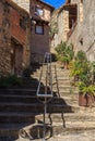 Stainless steel metal railing on stone staircase in village Royalty Free Stock Photo