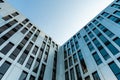 Stainless steel and mirrored glass facade of modern office building in front of sky during golden hour Royalty Free Stock Photo