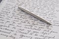 Stainless Steel Pen Laying on Written Page