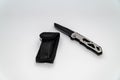 Stainless steel pocketknife with a black blade and a black case isolated on a white background