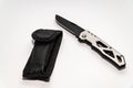 Stainless steel pocketknife with a black blade and a black case isolated on a white background Royalty Free Stock Photo