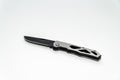 Stainless steel pocketknife with a black blade isolated on a white background