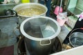 Stainless steel pot with variety of hot soup for boiling noodle. Get ready for cook noddle. Street restaurant