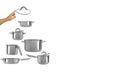 Stainless steel pots,saucepans,frying pan,ladle as pyramid or New Year tree,hand holding transparent glass lid on top