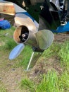 Stainless steel propellor on outboard engine in boatyard Royalty Free Stock Photo