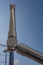 Stainless steel railing stairs from the outside of the building on a background of blue sky and beautiful clouds. Pipes, hinges, Royalty Free Stock Photo