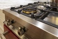 Stainless steel range / oven ketchen appliance burners and buttons with marble counter top