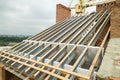 Stainless steel roof structure for future roof under construction. Development of metal roofing frame on house top Royalty Free Stock Photo