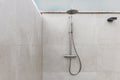 Stainless steel shower head in an outdoor shower on a terrace of a penthouse apartment