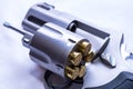 A stainless steel, snub nose 454 casull revolver, with the cylinder opened showing that it`s loaded