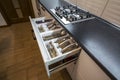 Stainless steel spoons, forks and knifes in cutlery box drawer in white kitchen cupboard Royalty Free Stock Photo