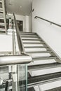 Stainless steel stairs, tempered glass and polished black granite steps Royalty Free Stock Photo