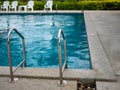 .Stainless steel stairs to the pool. handrails up and down the pool