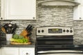 Stainless steel stove and kitchen utensils on the cooking table Royalty Free Stock Photo