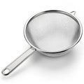 Stainless steel strainer with fine mesh isolated on white background Royalty Free Stock Photo