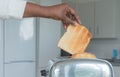 Stainless steel toaster toaster with fresh toasted bread for breakfast. Hands of African American Royalty Free Stock Photo