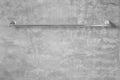Stainless steel towel on grey cement wall Royalty Free Stock Photo