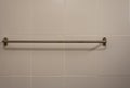 Stainless steel towel rack on white cement wall in the bathroom Royalty Free Stock Photo