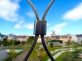 Abstract view of stainless steel mesh fence with clamps and blue sky background Royalty Free Stock Photo