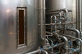 A stainless steel vat in the food industry at a brewery in the process of brewing beer. Background