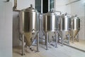 A stainless steel vat in the food industry at a brewery in the process of brewing beer. Background