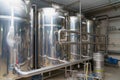 A stainless steel vat in the food industry at a brewery in the process of brewing beer. Background