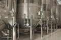 Stainless steel wine vats in a row inside the winery Royalty Free Stock Photo