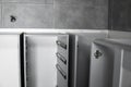 Stainless telescopic bayonet drawer slide guides, installed on a kitchen cabinet from gray chipboard. Accessories for Royalty Free Stock Photo
