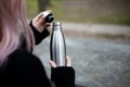 Stainless thermal bottle for water in hand.