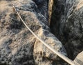 Stainless twisted rope anchored in rocky wall