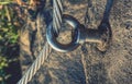 Stainless twisted rope anchored in rocky wall