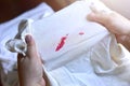 Stains of lipstick or makeup on white clothes or stains on clothes from everyday accidents. Concept of cleaning stains on clothes