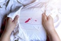 Stains of lipstick or makeup on white clothes or stains on clothes from everyday accidents. Concept of cleaning stains on clothes