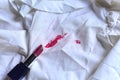 Stains of lipstick or makeup on white clothes or stains on clothes from everyday accidents. Concept of cleaning stains on clothes