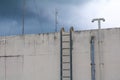 Stair old vertical industrial metal rusted. to Water tank no safety rails