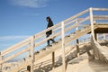 Stair wood dune access beach woman on wooden staircase of Lacanau atlantic ocean France