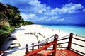 Staircase on a beautiful beach featuring pristine white sand and dazzling blue waters Royalty Free Stock Photo