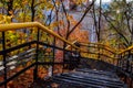 Staircase with colorful autumn and leaves. Old staircase in a city park. Autumn landscape. Royalty Free Stock Photo