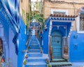 Staircase with colorful potted plants in Chefcaouen, `The Blue Pearl` of Morocco.