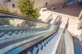 Staircase escalator bottom view on the outside street in the courtyard of the building. Look down descent view Royalty Free Stock Photo