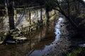 Staircase of a group of houses by the edge of a stream of water on a sunny day in the italian countryside